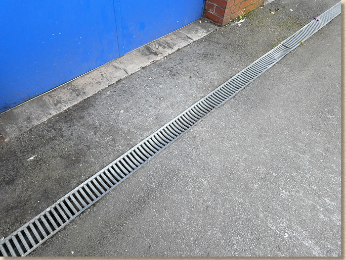 buckled grating on linear channel drain buckled grating on linear channel drain